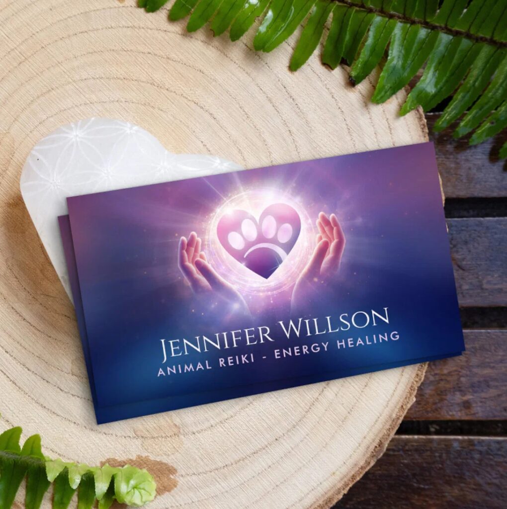 Animal Reiki business card with healing hands, radiant heart, and paw print symbol.